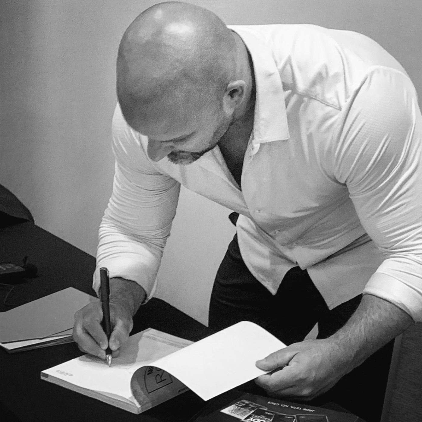 Dr. Jade Teta signing a book