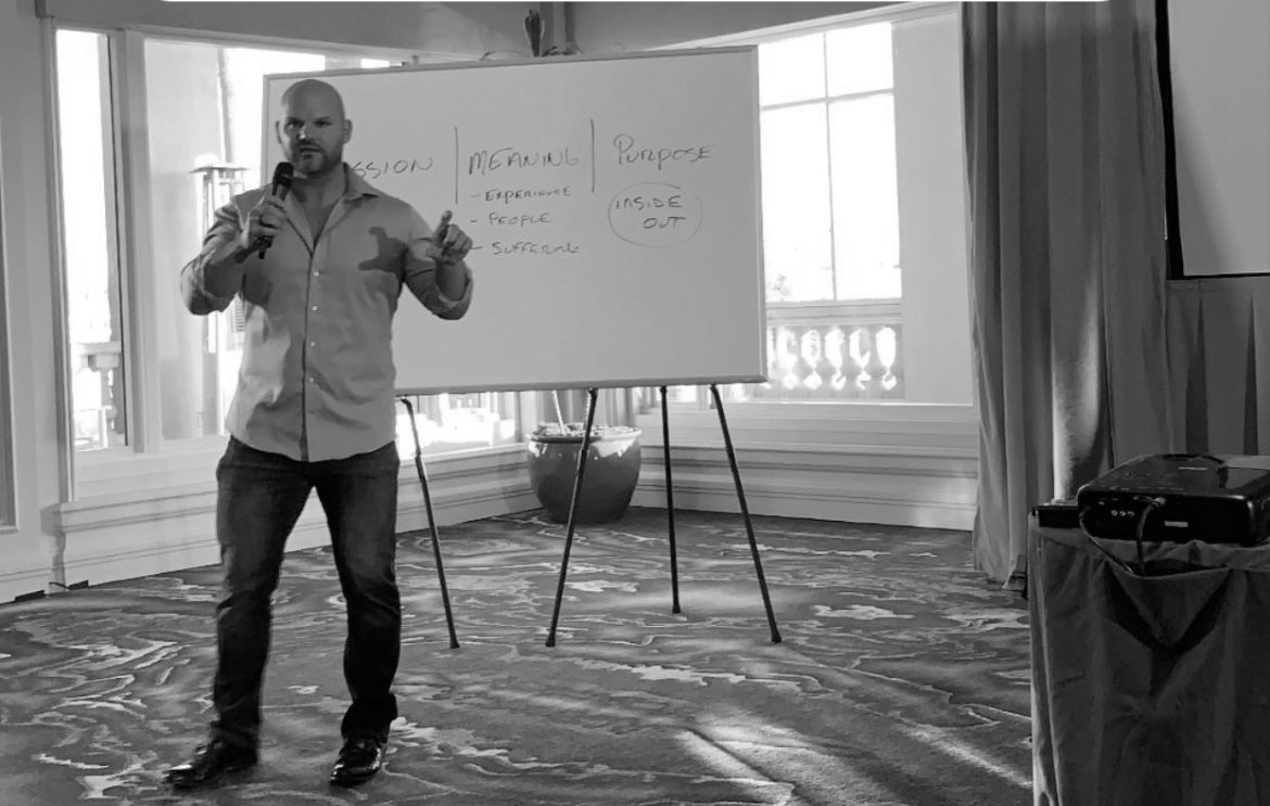Passion, meaning, purpose. A conference room, a whiteboard, a microphone.